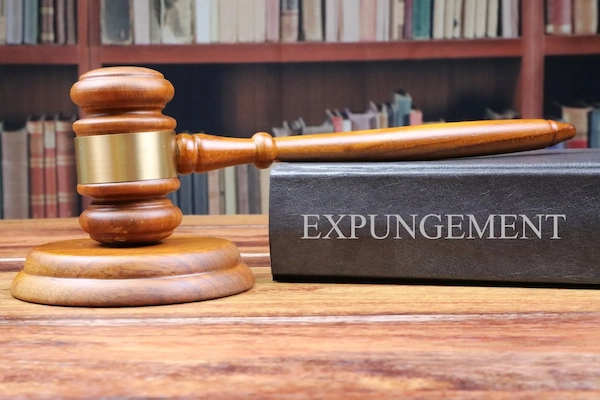 Wooden gavel and book titled "EXPUNGEMENT," symbolizing legal processes related to clearing DUI convictions in Texas.