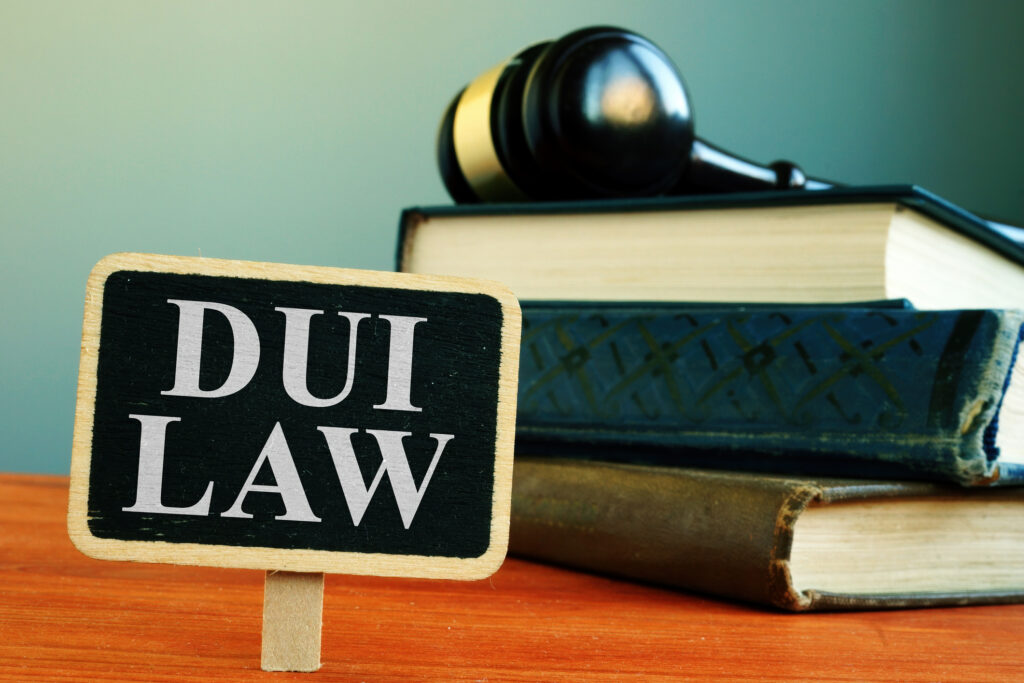 DUI law sign in front of stacked legal books and a gavel, representing legal representation for DUI cases in Texas.
