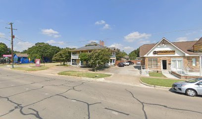Fort Worth office location of Bryan Fagan Law Office, featuring a two-story building with trees and parked cars, situated at a street intersection.