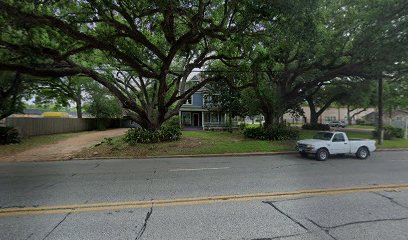 Historic house surrounded by large trees on Austin St, near the upcoming Richmond Office of Bryan Fagan Law Office.