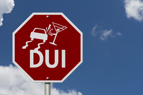 DUI warning sign featuring a car swerving and a cocktail glass, symbolizing the dangers of driving under the influence in Texas.