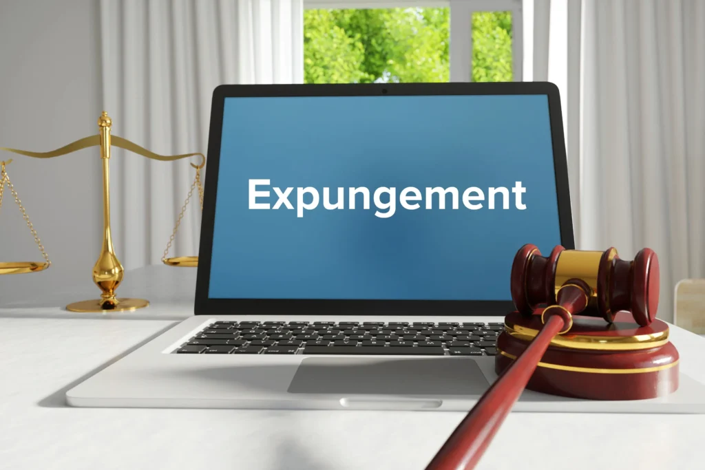 Laptop displaying "Expungement" on screen with gavel and scales of justice, symbolizing legal processes related to record sealing and DUI expungement in Texas.