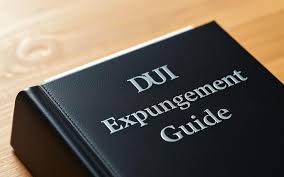 DUI expungement guidebook on wooden surface, relevant to Texas DUI record sealing and legal advice.