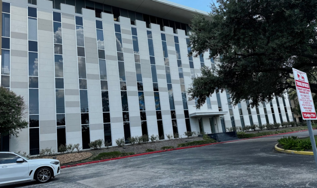 River Oaks office building of Bryan Fagan Law Office, modern architectural design, large glass windows, surrounded by landscaped area, Houston, Texas.
