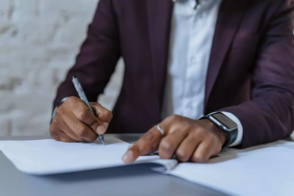 Person in a suit signing legal documents related to DUI representation in Texas.