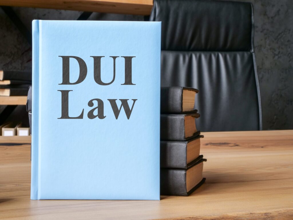 DUI law book on wooden desk with stacked legal books, representing legal guidance for DUI charges in Texas.